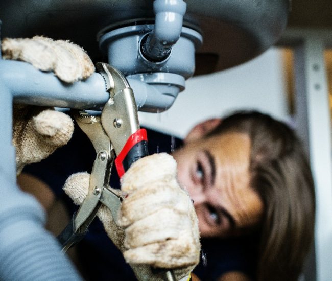Man fixing kitchen sink